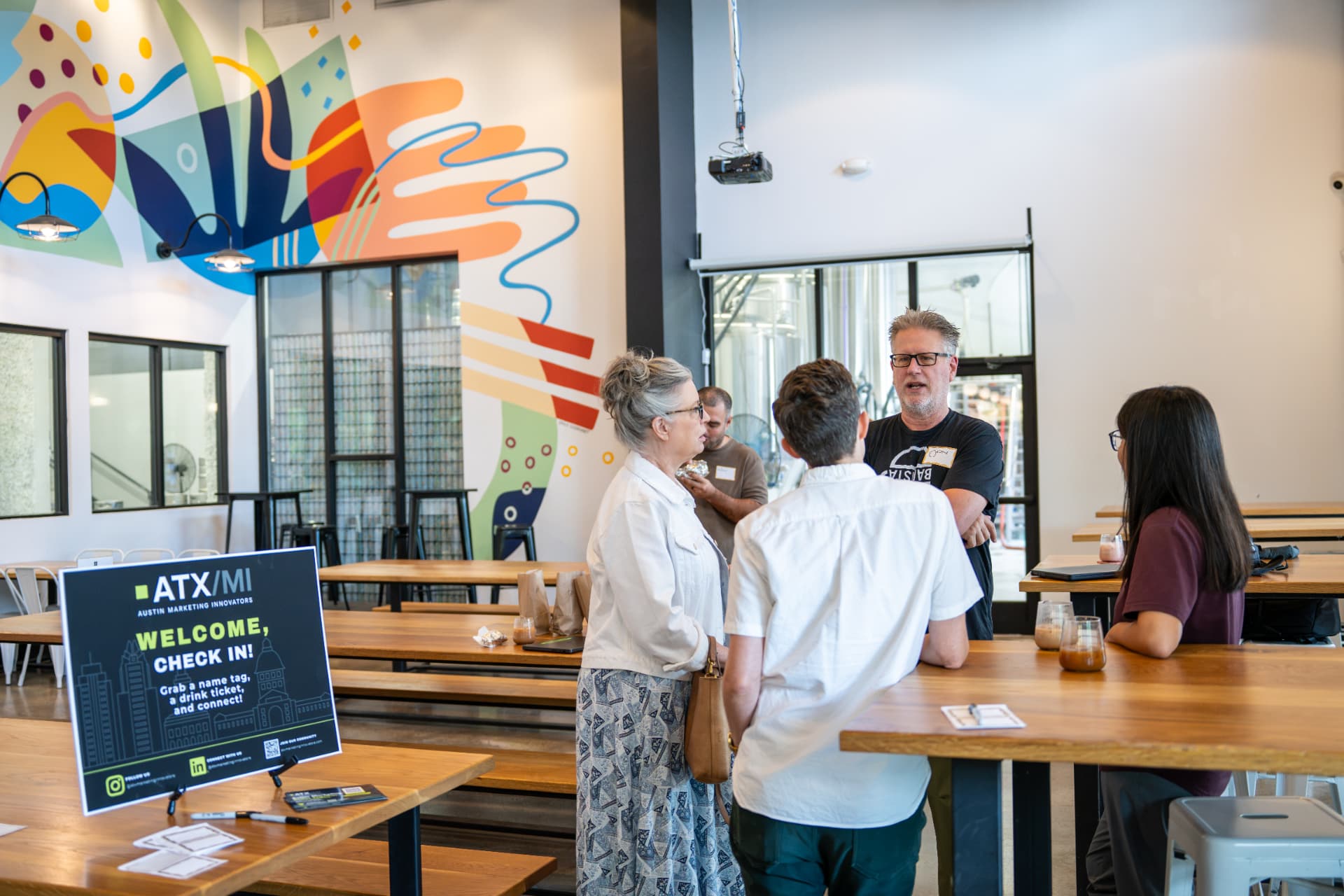 Check-in table and community members at an ATX Marketing Innovators power breakfast